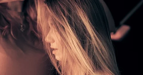 Very attractive blonde master does her hair, put make-up on her face, makes Stock Footage 99509310