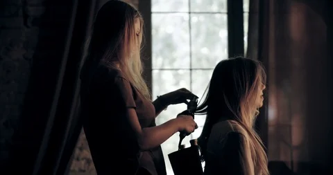 Very attractive blonde master does her hair, put make-up on her face, makes Stock Footage 99509346