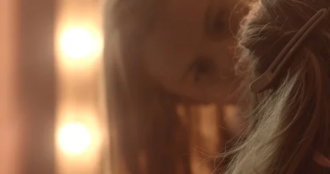 Very attractive blonde master does her hair, put make-up on her face, makes Stock Footage 99509543