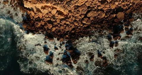 Very beautiful frame composition. Top view, rocky coast and raging sea. waves at Stock Footage 97300484