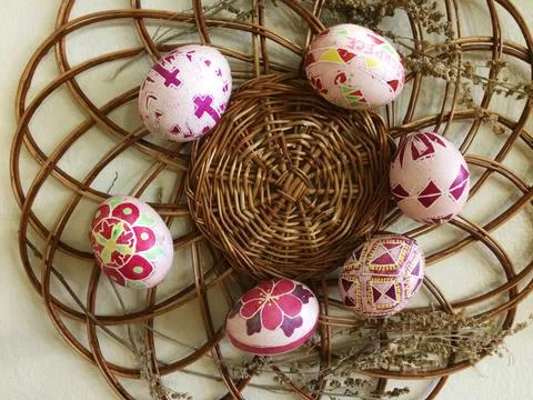 Very beautiful painted Easter eggs for celebrating Easter are placed on a wicker Stock Photos