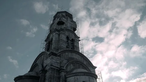 Very beautiful temple under construction on a background of flying clouds Stock Footage 88930325