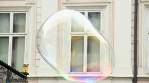 Very big soap bubble flies bursts on city street, gigantic Stock Footage 43682413
