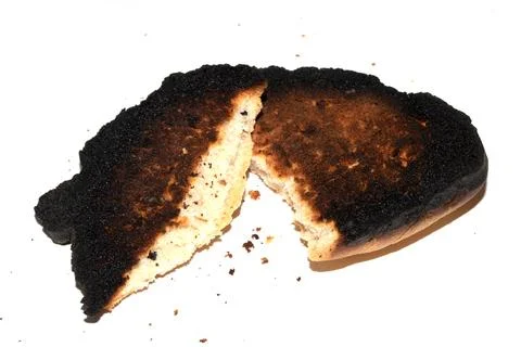 Very Burnt Bread Roll Torn or Cut in Half Toast Close Up Texture Foto stock