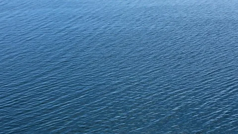 Very calm flat blue ocean water Stock Footage 93997641