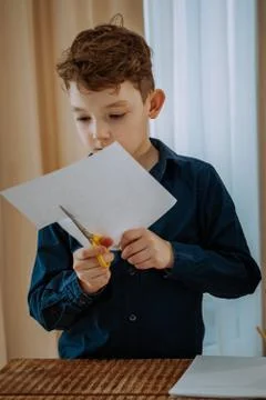 Very charismatic kid does something nice for the fine arts at school Stock Photos