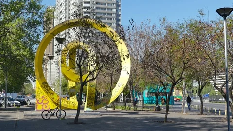 Very clean view of a yellow, abstract sculpture on a plaza Stock Footage 97862878
