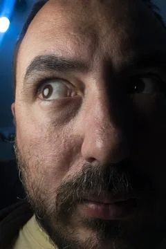 Very close up of the face of a scared man Stock Photos