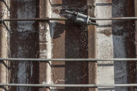 Very close front facing view of metal straps around an old concrete silo Stock Photos