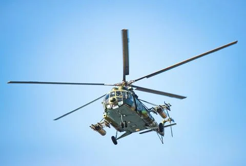 Very close frontal view of an attack helicopter against the sky, with missiles Stock Photos