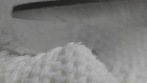 Very close macro view of a white fabric and scisors   Vídeo Stock 139426376