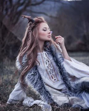 Very close portrait of cute woman in fairy tale image with horns on her head Stock Photos