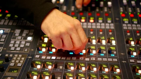 Very close-up of the recording console. a man's hand twists the tuning knobs 動画素材 128769816