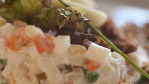 Very close-up Russian salad.Macro.Camera moves around a plate. Stock Footage 123770951