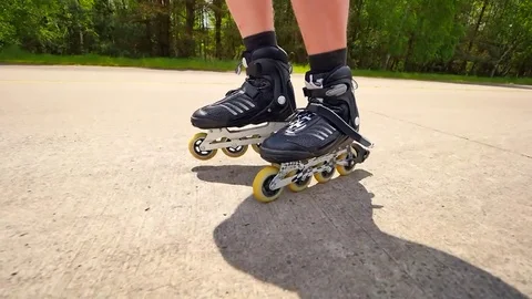 Very close up side view to working inline skates. Easy skating on the smooth  as Stock Footage 76059475