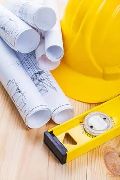 Very close up view on blueprints construction level helmet wooden boards Stock Photos