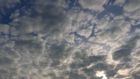 Very cloudy sky at sunrise with sun beams - background - time lapse Stock Footage 143380089