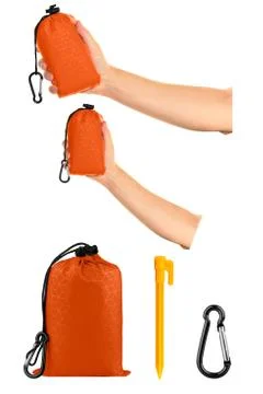 Very compact hand held orange nylon pocket blanket in a drawstring bag, with  Foto stock