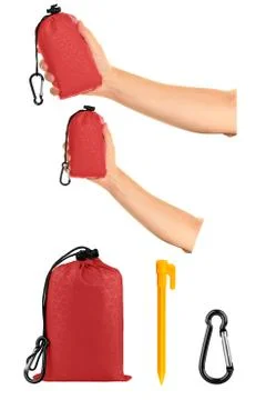 Very compact hand held red nylon pocket blanket in a drawstring bag, with pla Foto stock