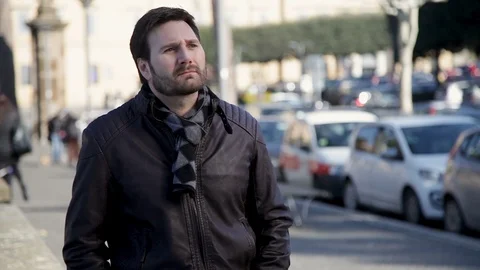 A very concerned man is nervously looking for something in his jacket pockets. Stockbeeldmateriaal 102278079