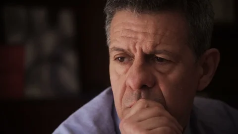 Very concerned Mature man thinking about the problem at the window Stock Footage 100928899
