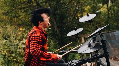 A very cool drummer in a checkered red shirt. Expressive performance. Stock Footage 114519437