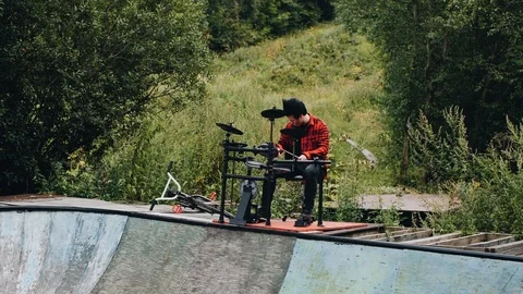 Very cool drumming. the guy plays on the edge of the old pool. Very nice shots. Stock Footage 114519503