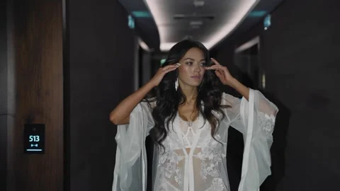 A very cool girl is walking down the corridor straightening her hair Stock Footage 201969241