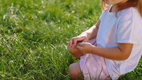 Very cute little girl down on the grass ... | Stock Video | Pond5