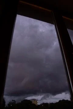 Very dark clouds outside of a window Photos