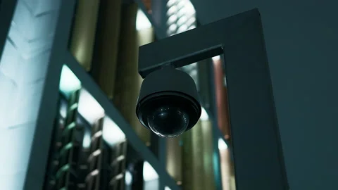 VERY DARK view over a CCTV camera against a modern building at night Stock Footage 224175430