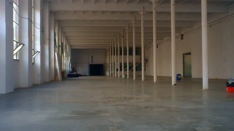 Very deep shot of a huge white colored industrial hangar, Stock Footage 100883943