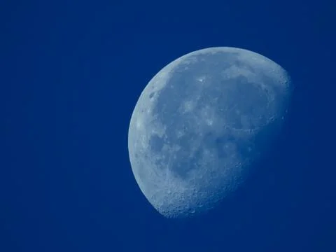 A very dense close-up of a decreasing moon in the morning sky Stock Photos