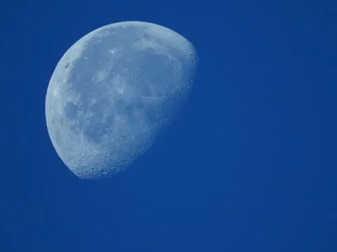 A very dense close-up of a decreasing moon in the morning sky Stock Photos