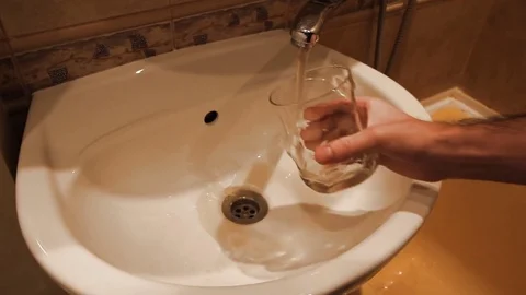 Very dirty rusty water in the sink at the tap. utilities do not work Stock Footage