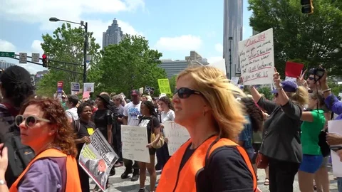 A very diverse crowd with signs protesting in Atlanta during May Day Stock Footage 76776843