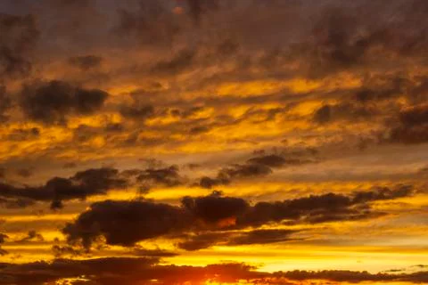 Very dramatic clouds in the crimson sky at sunset in summer Stock-Fotos