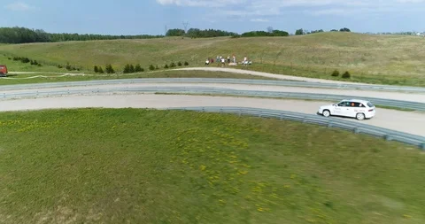 Very dynamic almost hit drone shot of racing car Stock Footage 89416364