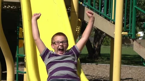 Very excited boy coming down slide Video stock 12092022