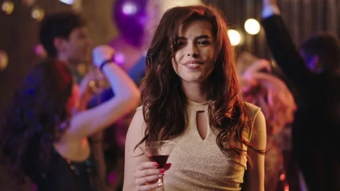 Very excited lady in front of the camera at stuff party drinking some cocktail Video stock 144486415