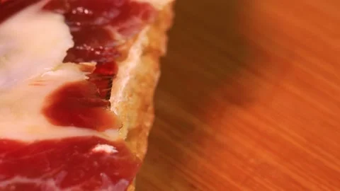 Very fatty cured ham slice on top of bread, macro shot. Rotating motion of 스톡 동영상 172460002