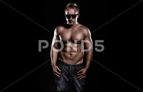 A very fit young male flexing his muscles Stock Photos