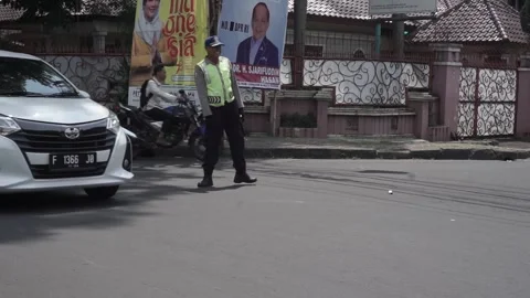 A very friendly and warm traffic policeman on duty at the roadside Stock Footage 254068427