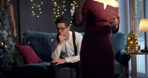A very frustrated young man gets bored and sad at a party while others hang out Stock Footage 194865396