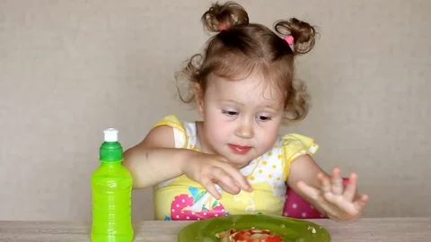 Very funny child eats pizza and drinks lemonade. Cafe and fast food. Little Stock Footage 80052013