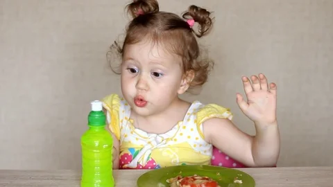 Very funny child eats pizza and drinks lemonade. Cafe and fast food. Little cute Stock Footage 82036350