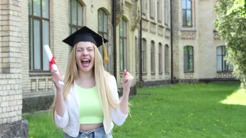 Very happy graduate woman in black hat at the university campus. Stock Footage