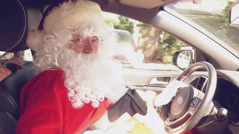 Very happy Santa Claus saying hello ok sign while driving car 4K closeup Stock Footage