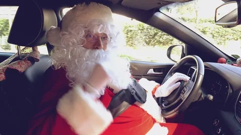 Very happy Santa Claus saying hello ok sign while driving car 4K Stock Footage