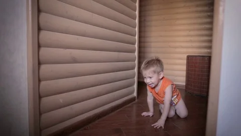 Very happy two year old child boy is lying on floor and playing with a toy car. Stock Footage 99474907